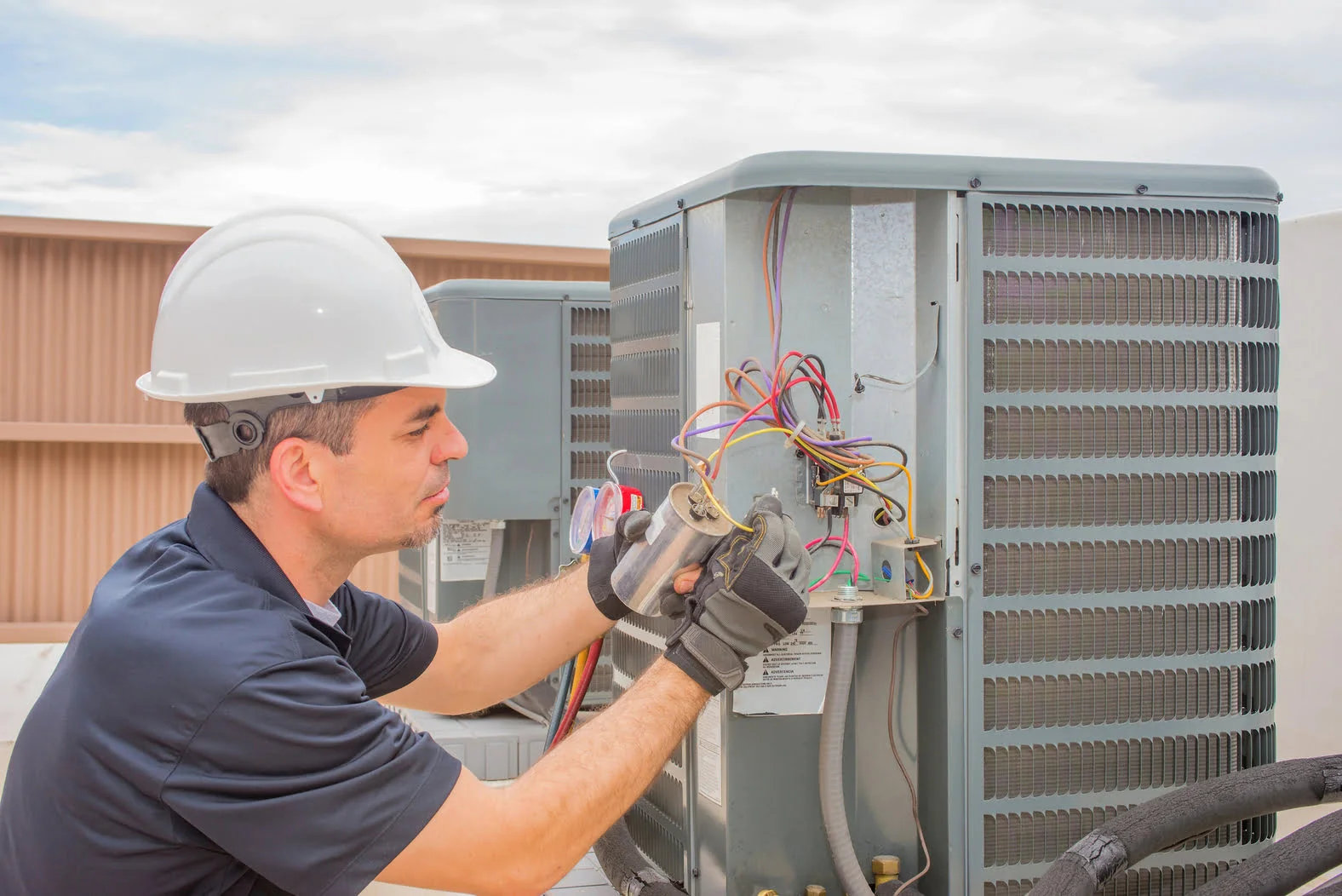 Licensed, trusted, professional electrician repairing and wiring a residential home generator.